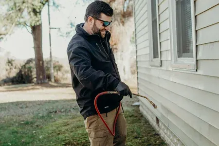 spraying exterior of home
