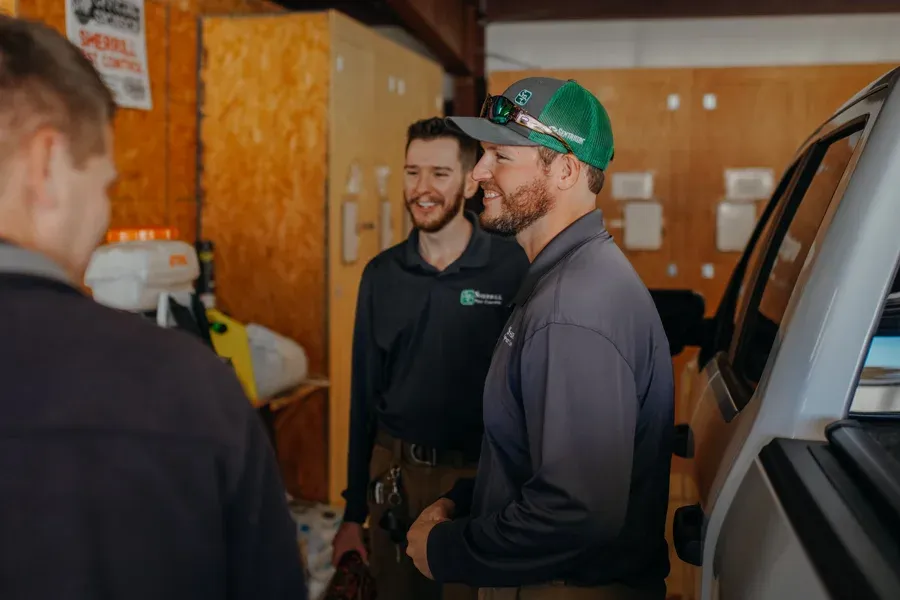 pest control technicians laughing and talking
